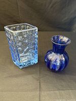 Two cobalt blue glass vases: square textured vase and bulbous bud vase