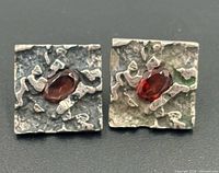 front view of both earrings showing overall design and garnet placement