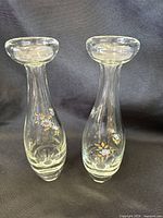 Front view of two matching clear glass bud vases