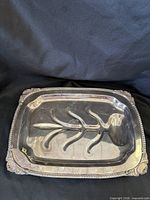 Top view of silver-tone carving tray showing tree well pattern and border details