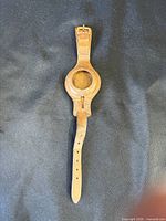 Front of leather watch strap showing circular watch holder and buckle