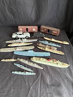 Group shot of all items: boxcar, vehicles, multiple ship models