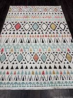 Full view of rug showing complete geometric pattern and cream background