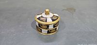 Lidded brass and mother-of-pearl trinket box front angle