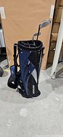 Blue and black Dunlop carry bag standing upright with clubs inserted