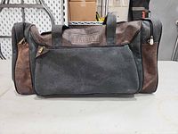 Front view of Jaguar duffel showing color, material, front zip pocket and logo