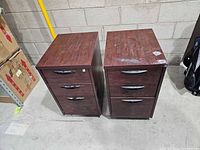 Front view of both pedestals showing drawer fronts, handles and overall wear