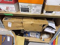 Two taped cardboard cartons on shelf labeled lot 448