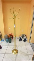 Full view of brass-tone metal coat tree