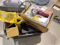 Basket containing boxed Skil driver, socket set case and other hand tools