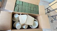 Open box showing stacked green Oasis foam bricks