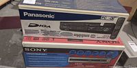 Stacked view of Panasonic DIGA and Sony RDR-HX900 recorder boxes