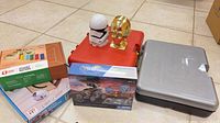 Group shot of all items: two Meccano cases, three boxed kits, two Star Wars head figures