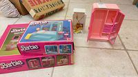 Two boxed Barbie sets plus loose wardrobe and cleaning closet displayed on floor