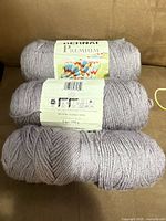 Three Bernat Premium purple skeins