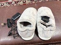 Top view of slippers showing battery pack and cable