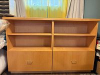Front view of entire light maple storage unit showing shelves and drawers