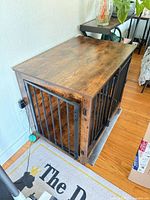 Three-quarter view of wood and metal dog crate showing overall construction and finish