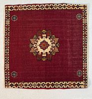 Full view of square Shiraz Qashqai rug showing red field, central medallion and border