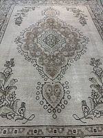 Full view of antique Tabriz rug showing central medallion and floral borders
