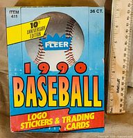Front view of Fleer 1990 Baseball Logo Stickers & Trading Cards 36ct box showing graphics and ruler for scale
