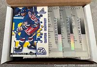 Wayne Gretzky card and several checklist cards visible in open box