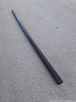Full view of entire black ABS pipe laid on ground