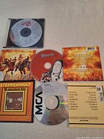 All three CDs with their respective jewel cases and inserts displayed