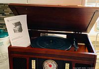 Turntable under open lid with manual visible