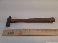 Full view of the hammer beside 12 in ruler for scale
