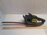 Full view of Black & Decker hedge trimmer alongside ruler
