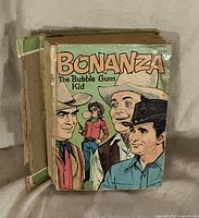 Front cover showing title and characters, spine damage visible