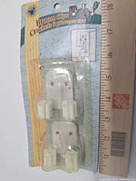 Front view of blister card showing two broom clips and size reference ruler