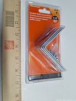 Front of sealed Hillman Essentials package showing four 2-1/2" double-wide corner braces and screws