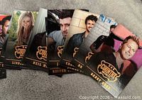 Fanned out view of multiple Country Music cards showing several artist fronts