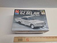 Front of sealed AMT model kit box showing car image, title, brand logos, skill level