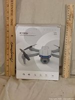 Front of C99 drone box showing grey drone image, age rating, icons
