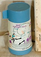 Front view showing The Flying Nun graphics, cap, base, ruler for scale