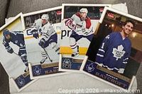 Four sample cards showing Andrew Raycroft, two Toronto Maple Leafs in action, and a Montreal Canadiens player, illustrating card design