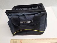 Front view of Mastercraft nylon tool bag showing logo, handles, pockets, yellow piping, ruler for scale