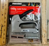 Front of sealed package showing tool, staples and branding