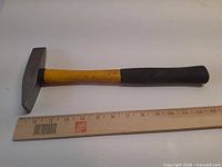 Full view of Power Fist chipping hammer beside ruler for scale