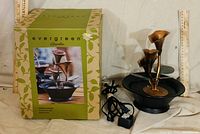 Box and assembled fountain with pump and cord visible