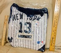 Front of sealed jersey-style drawstring backpack showing NEW YORK, number 13, RODRIGUEZ, MLB logo