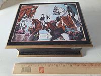 Top view of closed box showing equestrian print and scale ruler