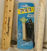 Front view of sealed Yoda Pez dispenser on Star Wars card