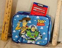 Front view of lunch bag showing Toy Story graphics and hang tag