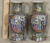 Front view of both porcelain vases beside ruler for scale