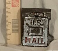 Front view showing U.S. MAIL lettering and scale