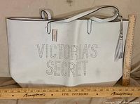 Front view showing perforated logo, overall size reference with rulers